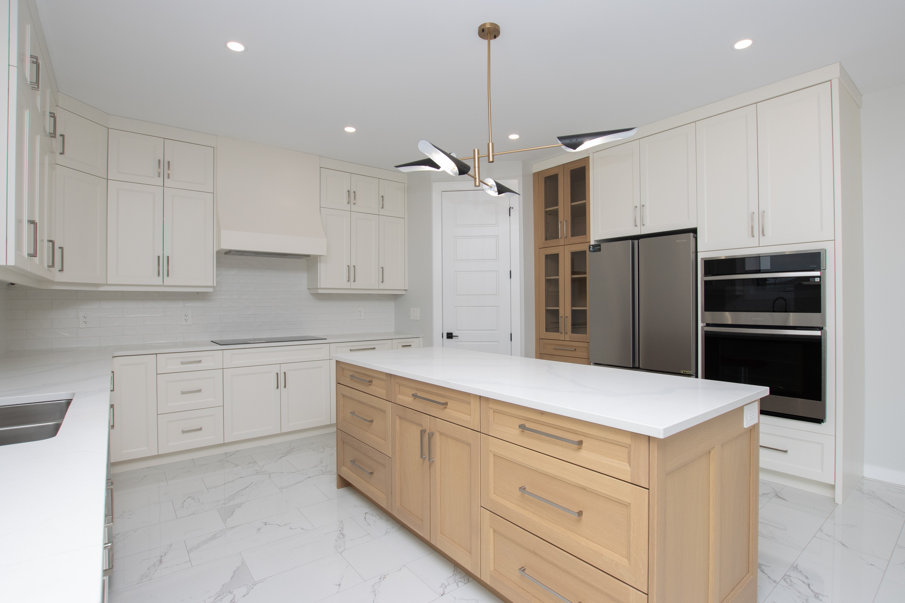 Kitchen with natural wood island and gold pendant lighting