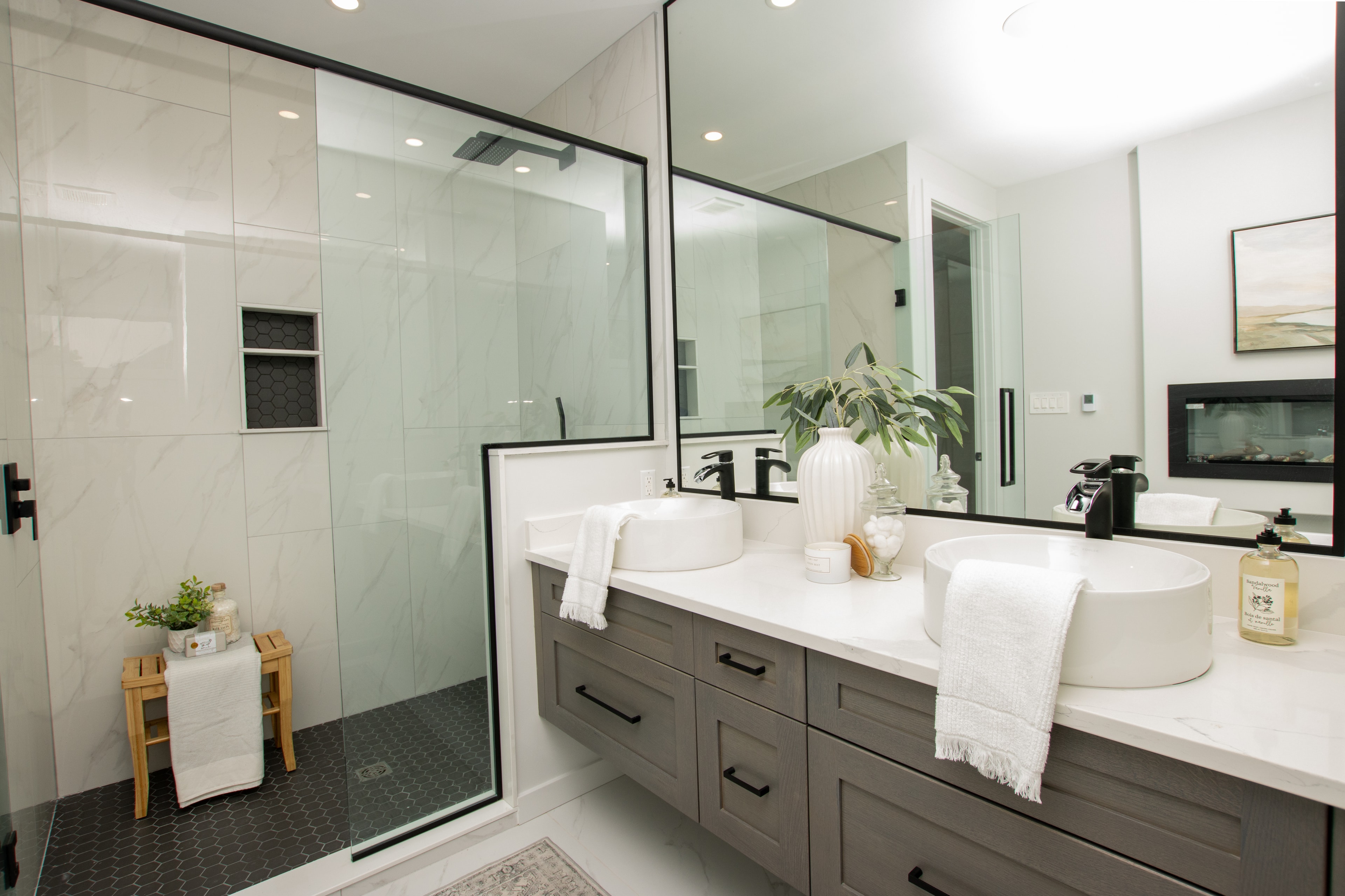 Ensuite with double vessel sinks, grey floating vanity and glass shower