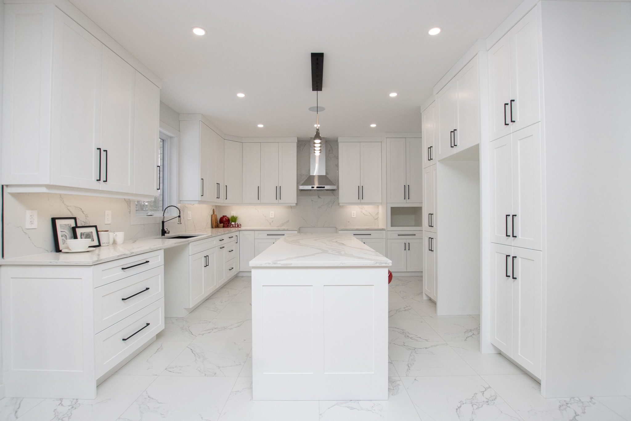 115 Optimist Drive — bright white kitchen with marble countertops and large island
